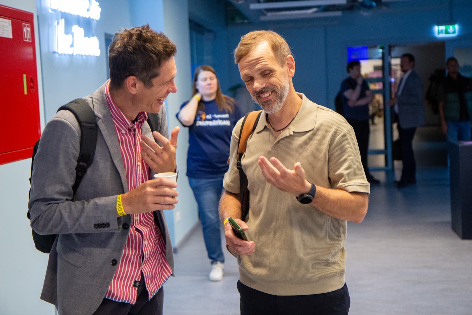 Two attendees laughing during a networking break