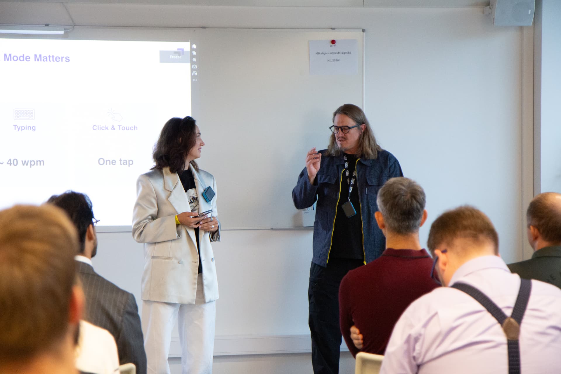 Speakers presenting in a workshop room